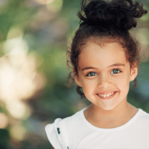 Little girl smiling, showing healthy teeth
