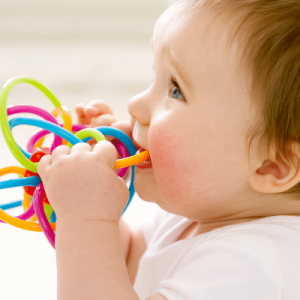 Little baby teething on teething rings