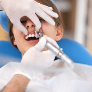 Young boy getting his teeth fixed at the dentist, representing emergency dental care