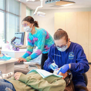 Dentist and team member work on a patient's teeth at Puget Sound Pediatric Dentistry