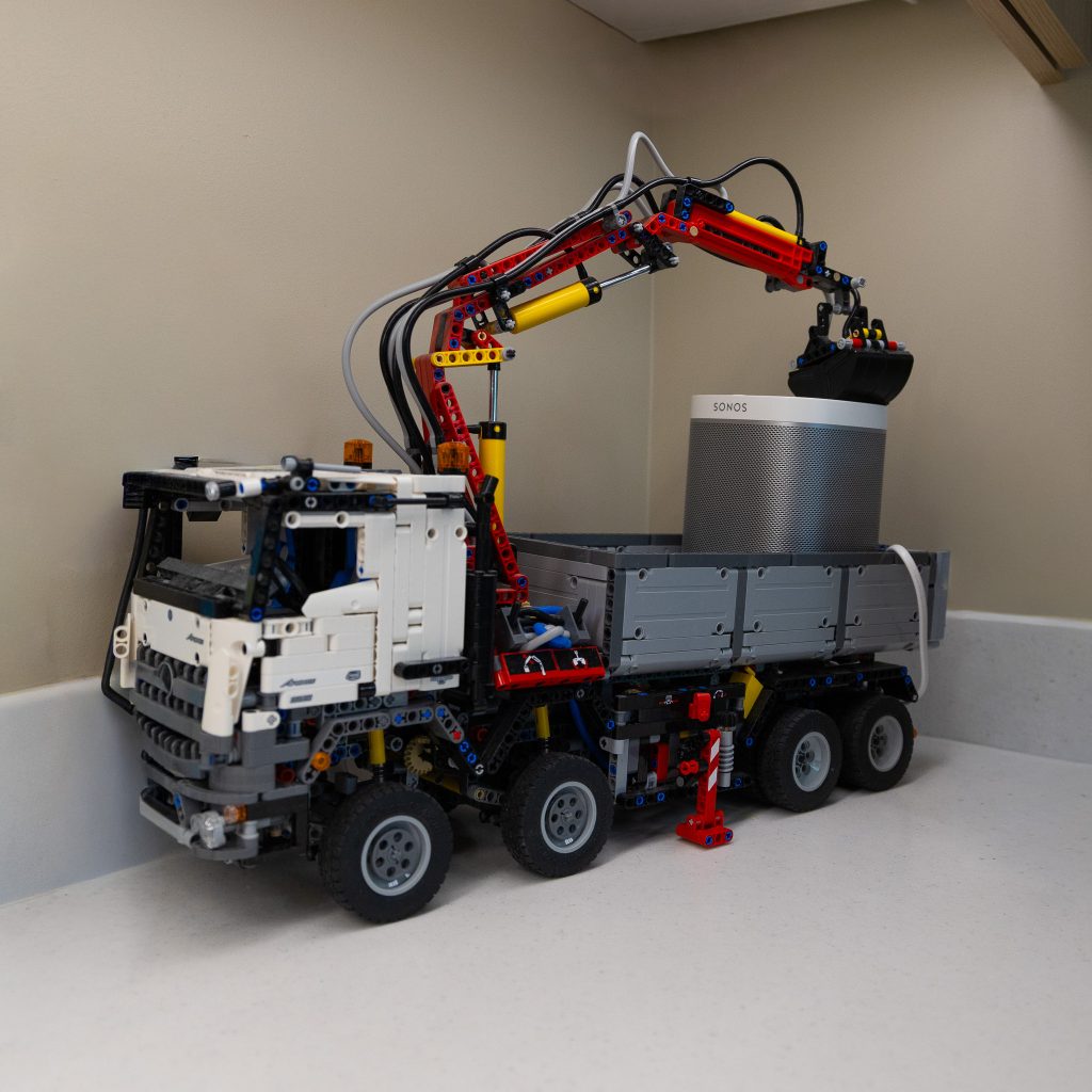 Lego pickup truck with a crane carrying a bluetooth speaker
